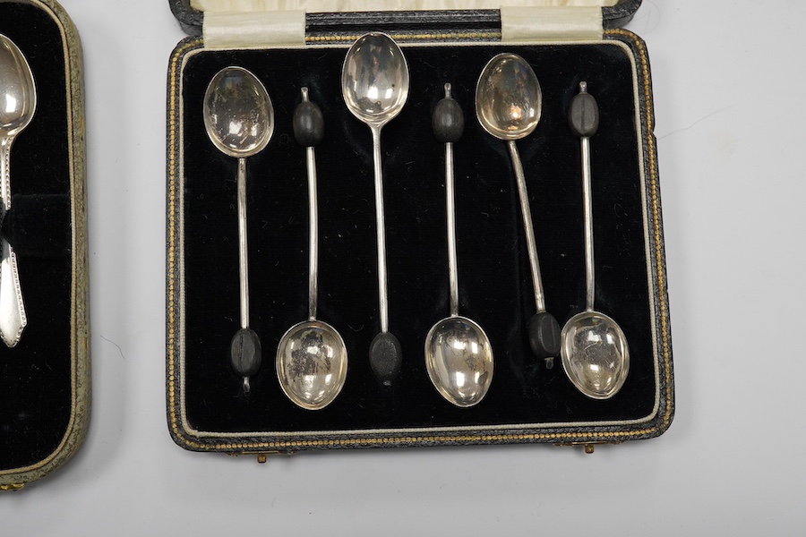 A cased set of twelve late Victorian silver coffee spoons, by Goldsmiths & Silversmiths Co Ltd, London, 1890 and three other later cased silver sets including six bean end coffee spoons, eight coffee spoons and twelve pa